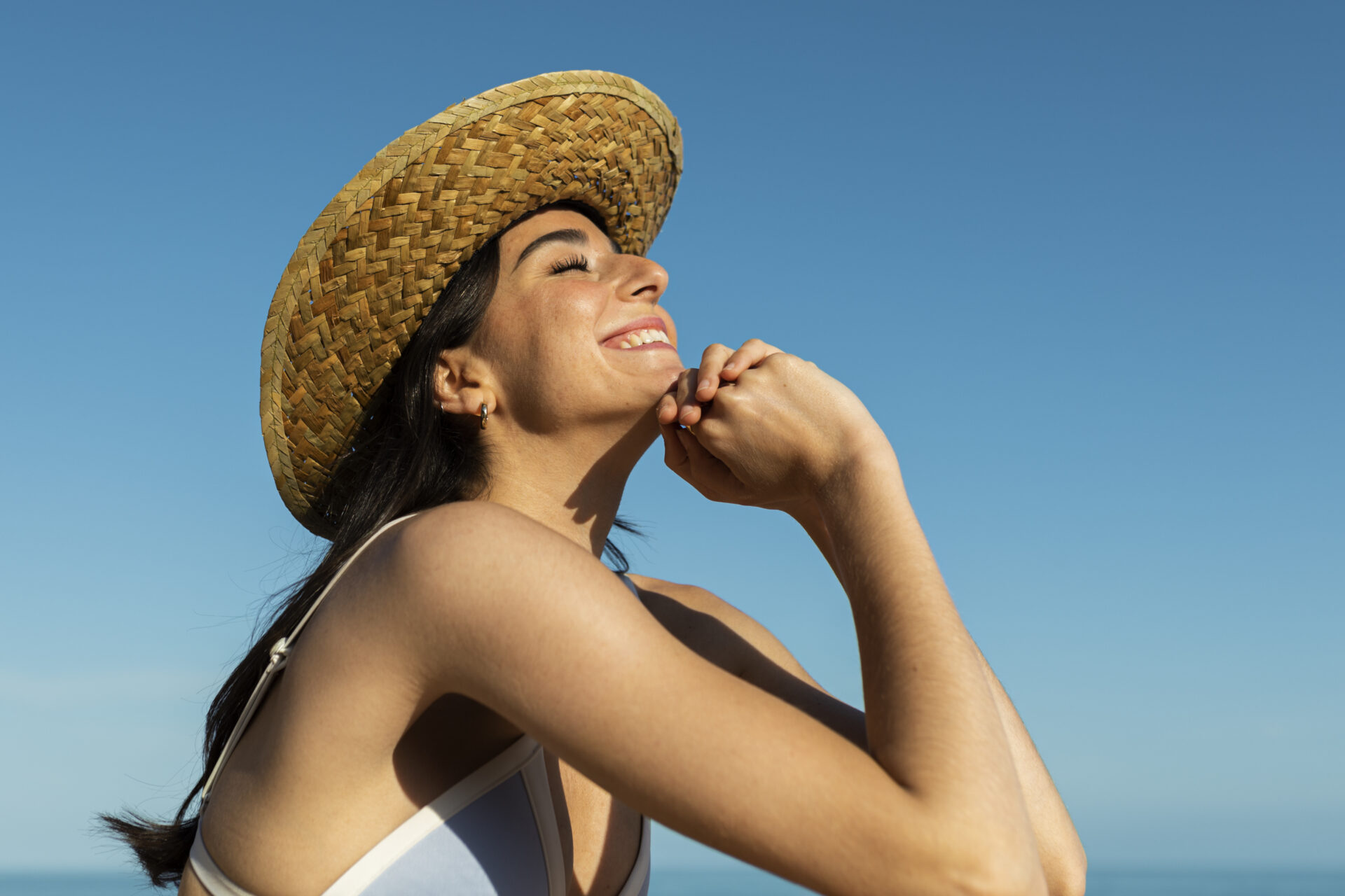 smiley woman posing beach side view