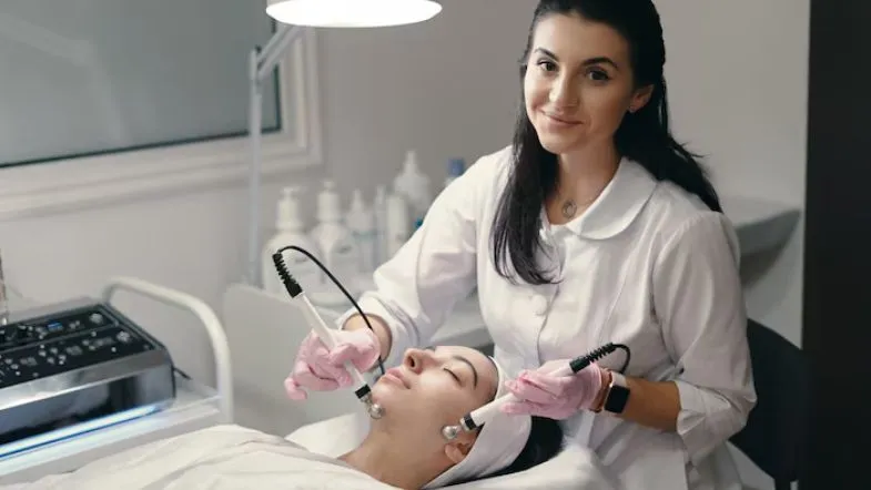Procedimento estético facial com equipamento de alta tecnologia realizado por profissional qualificada.