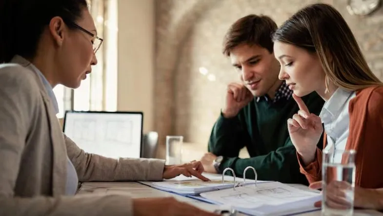 Gestão Comercial: transforme sua carreira e amplie sua visão de mercado 6 Consultora comercial orienta clientes em reunião de planejamento estratégico no setor de vendas.