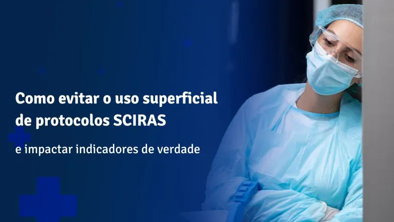 Enfermeira paramentada com máscara, touca e avental cirúrgico, observando atentamente um monitor em ambiente hospitalar.