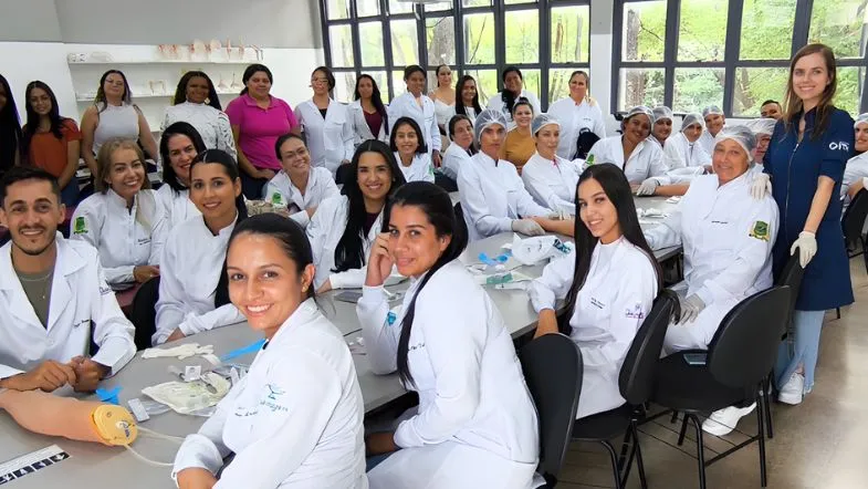 Turma de alunos de estética avançada em laboratório realizando atividades práticas supervisionadas.